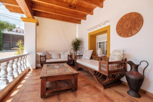 a porch with a couch and a table at Villa Alba in Santa Eularia des Riu