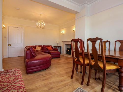 a living room with a table and a couch at Fir Grove in Menai Bridge