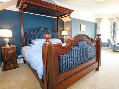 a bedroom with a large canopy bed in a room at Fir Grove in Menai Bridge