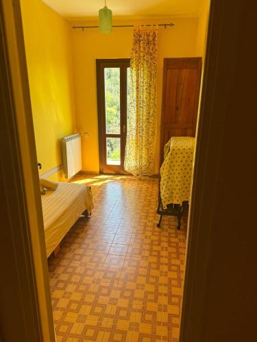 a bedroom with a bed and a window and a chair at Casa Franceschini in Poggio Mirteto
