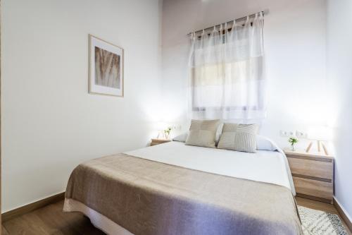 a white bedroom with a large bed and a window at Casa Rural La Resbala - Casa Cardon in La Orotava