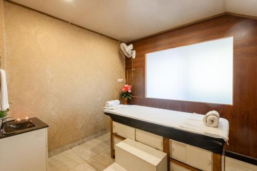 a bathroom with a sink and a window at Hotel Shiva Sanctuary by DLS Hotels, McLeod Ganj in Dharamshala