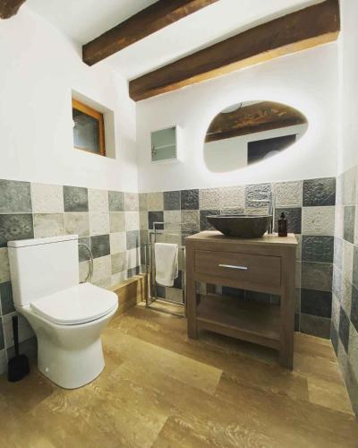 a bathroom with a toilet and a sink at Emerald Coast Gites and Lodge in Hénansal