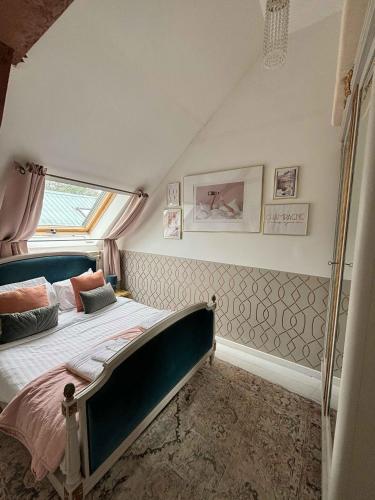 a bedroom with a bed and a window in it at Emerald Coast Gites and Lodge in Hénansal