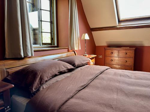 a bedroom with a bed and a window at The Old Forge B&B and Glamping in Compton Abbas