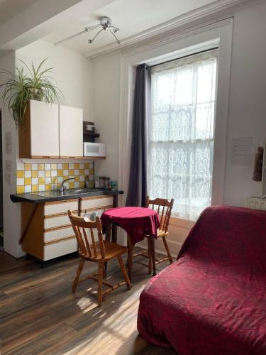 a bedroom with a bed and a table and chairs at Bryn Awel in Aberystwyth