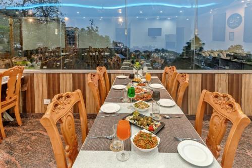 a table with food on top of a balcony at Hotel Shiva Sanctuary by DLS Hotels, McLeod Ganj in Dharamshala