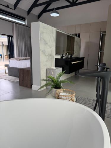 a bathroom with a sink and a mirror at blydebushvilla in Hoedspruit