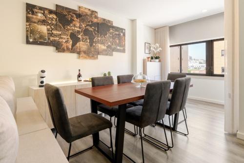 a dining room with a table and chairs at Spacious & Stylish Flat with Garage by HostWise in Ermesinde