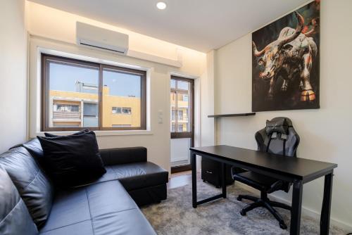 a living room with a couch and a table at Spacious & Stylish Flat with Garage by HostWise in Ermesinde