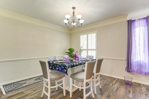 a dining room with a table with chairs and a chandelier at Patio, BBQ and Yard Family Retreat in Pearland in Pearland