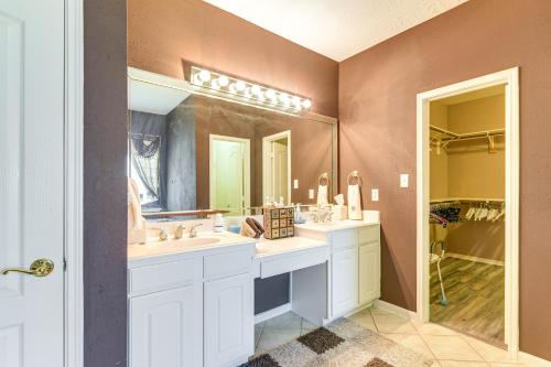 a bathroom with two sinks and a large mirror at Patio, BBQ and Yard Family Retreat in Pearland in Pearland