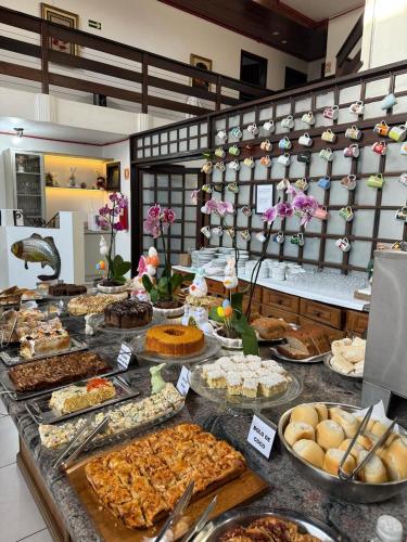 a buffet with many different types of food on a table at Pousada Brisa do Mar in Torres