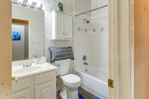 a bathroom with a toilet and a sink and a bath tub at Patio, BBQ and Yard Family Retreat in Pearland in Pearland