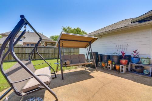 a porch swing in a backyard with a house at Patio, BBQ and Yard Family Retreat in Pearland in Pearland