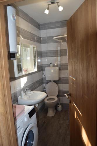 a small bathroom with a toilet and a sink at Apartman Željko in Zadar