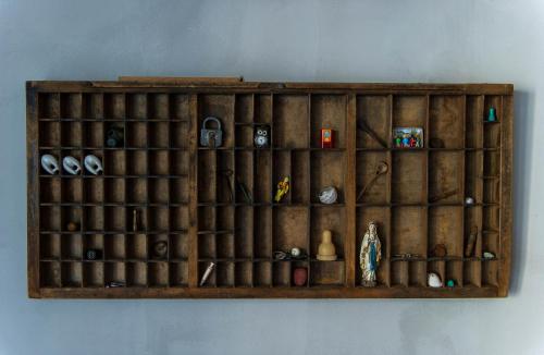 a wooden shelf with items on a wall at Thingvellir Chateau in Selfoss
