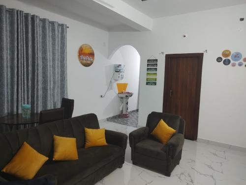 a living room with a couch and two chairs at ABDB 1bhk in Guwahati