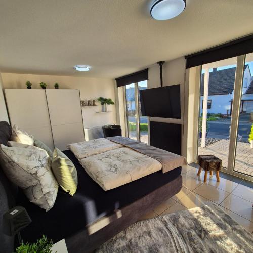 a bedroom with a large bed and a television at Ferienwohnung Goldrausch in Bernkastel-Kues