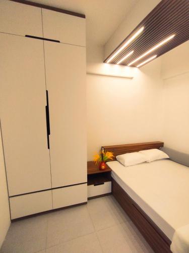 a bedroom with a bed and a large closet at WARM House Cần Thơ in Can Tho