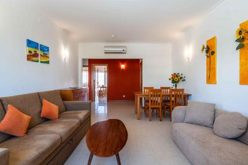 a living room with a couch and a table at Apartamentos Monte da Vinha I in Albufeira