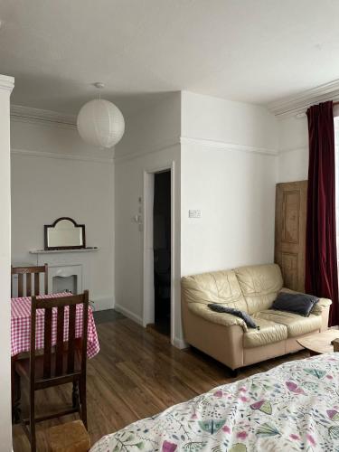 a living room with a couch and a bed at Bryn Awel in Aberystwyth
