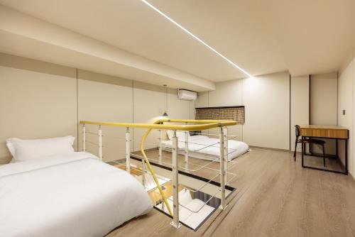 a bedroom with a bed and a table and a desk at Shanghai Zhuzhu Hotel - 24-hour free airport pick-up and drop-off at Pudong Airport in Shanghai