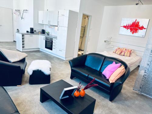 a living room with a couch and a table at Stylish & central #LoftWerk 2 in Velbert