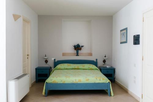 a bedroom with a blue bed and two blue tables at Residence Del Casalnuovo in Matera