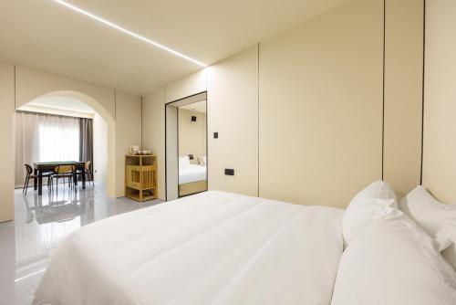 a bedroom with a large white bed and a table at Shanghai Zhuzhu Hotel - 24-hour free airport pick-up and drop-off at Pudong Airport in Shanghai