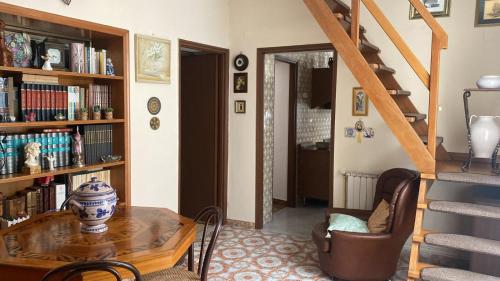 a living room with a table and a book shelf at La Casa in Piazza in Maratea