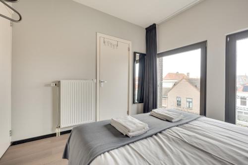 a bedroom with a large bed with two pillows on it at Hotel Zilt in Vlissingen