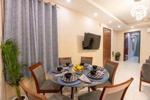 a dining room with a table and chairs at Homlee-Anupam 3BHK-Lift-Parking-Saket-Max Hospital in New Delhi