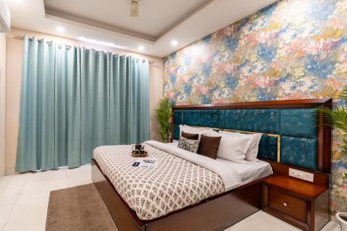 a bedroom with a bed with a painting on the wall at Homlee-Anupam 3BHK-Lift-Parking-Saket-Max Hospital in New Delhi