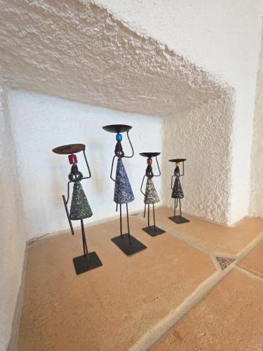 a group of little statues in a corner of a room at Casa Carina - Enchanted rustico in Mergoscia in Mergoscia