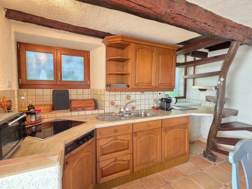 a kitchen with wooden cabinets and a sink at Casa Carina - Enchanted rustico in Mergoscia in Mergoscia