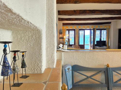 a living room with a counter and a room with windows at Casa Carina - Enchanted rustico in Mergoscia in Mergoscia