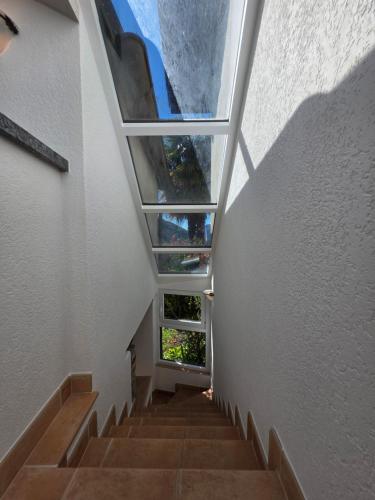 a staircase in a building with a glass ceiling at Casa Carina - Enchanted rustico in Mergoscia in Mergoscia