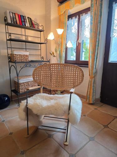 a chair sitting in a room with a book shelf at Casa Carina - Enchanted rustico in Mergoscia in Mergoscia
