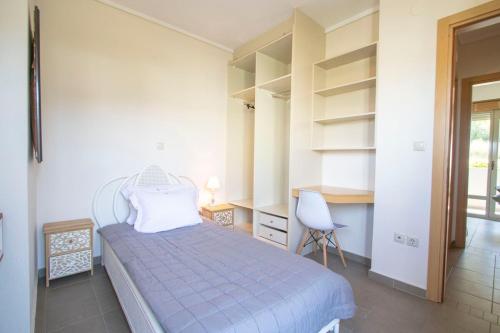 a bedroom with a bed and a desk and a chair at MD Pool Villa in Chroussos by Halkidiki Villas in Paliouri