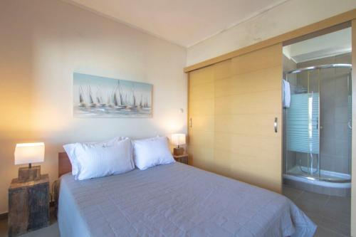 a bedroom with a bed and a glass shower at MD Pool Villa in Chroussos by Halkidiki Villas in Paliouri