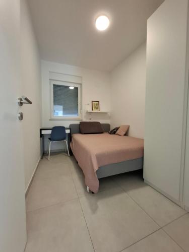 a bedroom with a bed and a desk and a chair at Casa Bučina in Umag
