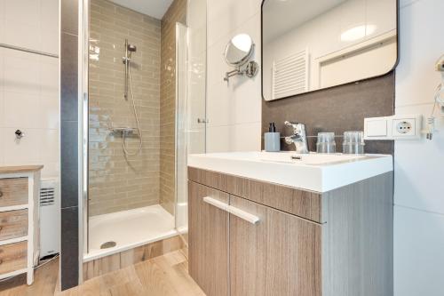 a bathroom with a sink and a shower at Hotel Zilt in Vlissingen