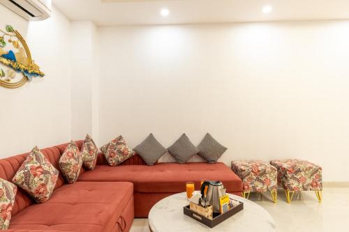 a living room with a red couch and chairs at Homlee-Anupam 3BHK-Lift-Parking-Saket-Max Hospital in New Delhi