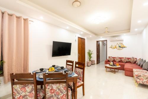 a living room with a table and chairs and a couch at Homlee-Anupam 3BHK-Lift-Parking-Saket-Max Hospital in New Delhi