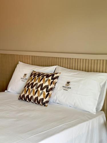 a bed with two pillows on top of it at Deck dos lençóis pousada in Barreirinhas