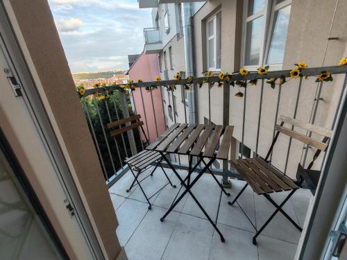 a balcony with two chairs and a table on a balcony at Star #3C315 in Golčŭv Jeníkov