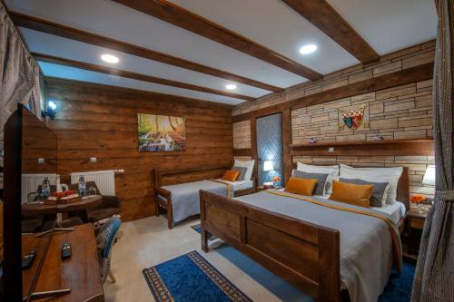 a bedroom with a large bed and a desk and a desk at Lakeside Hotel Plitvice in Plitvička Jezera