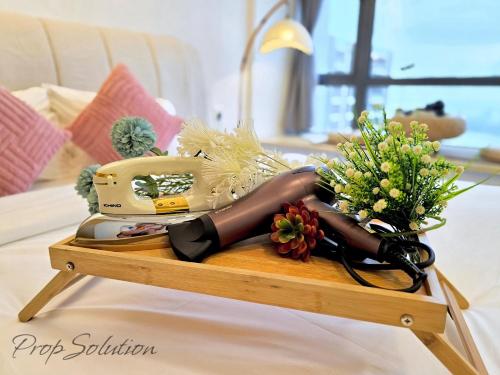 a woman laying on a table with a sewing machine at Cozy Seaview Suite Johor Bahru CIQ in Johor Bahru