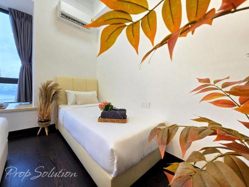 a bedroom with a bed with a plant at Cozy Seaview Suite Johor Bahru CIQ in Johor Bahru